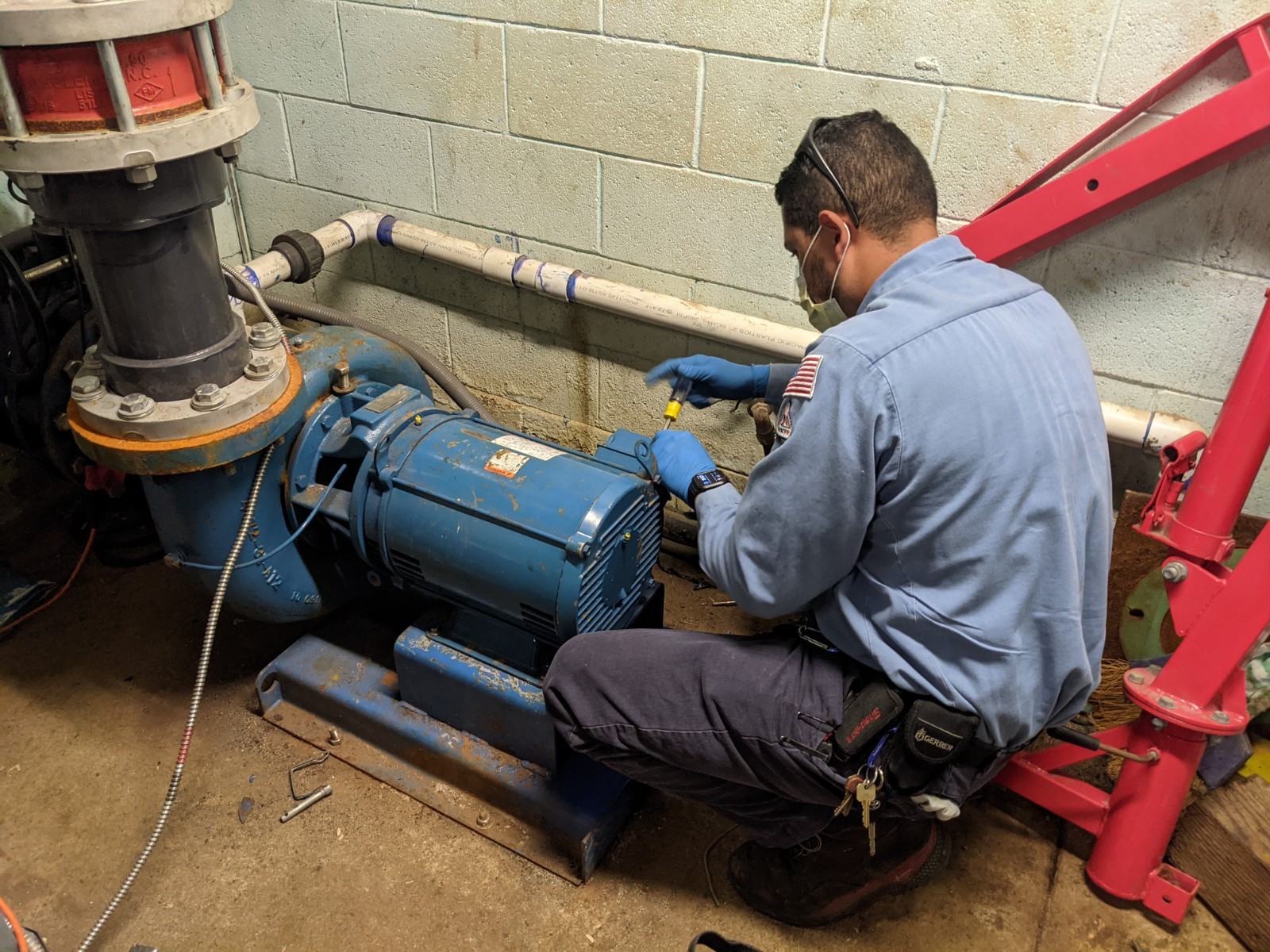 technician from PumpMan-SoCal performing maintenance on a water or wastewater pump system